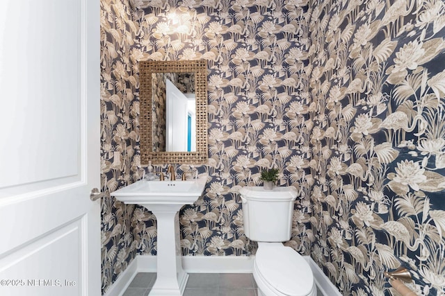 bathroom featuring tile patterned flooring and toilet