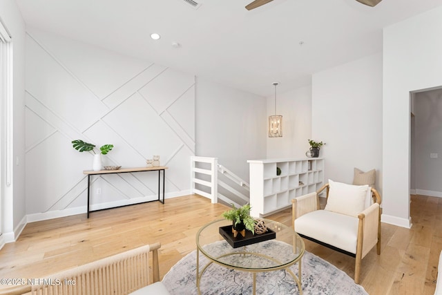 sitting room with hardwood / wood-style floors and radiator heating unit