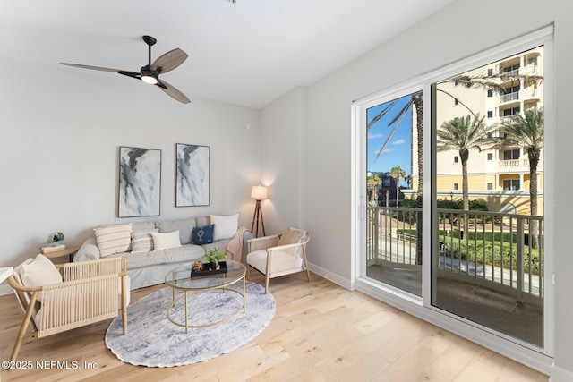 living room featuring ceiling fan and light wood-type flooring