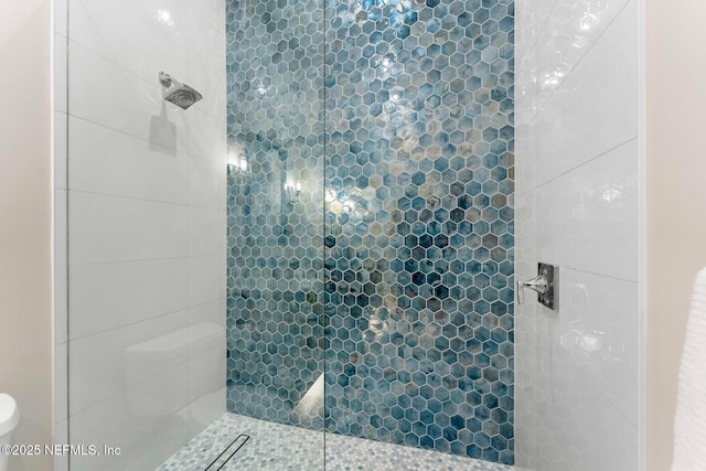 bathroom with a tile shower