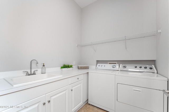 laundry room with cabinets, independent washer and dryer, light tile patterned flooring, and sink