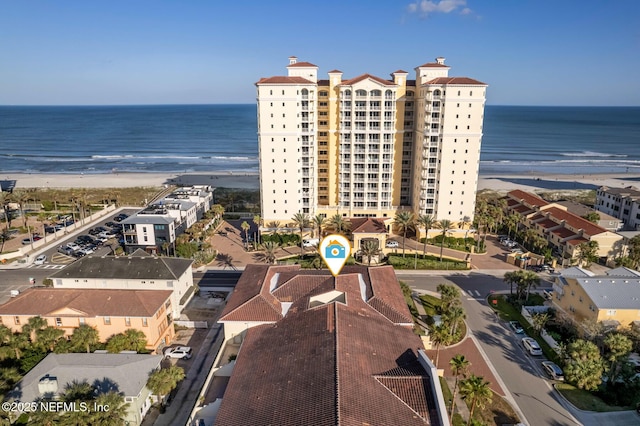 birds eye view of property with a water view and a view of the beach