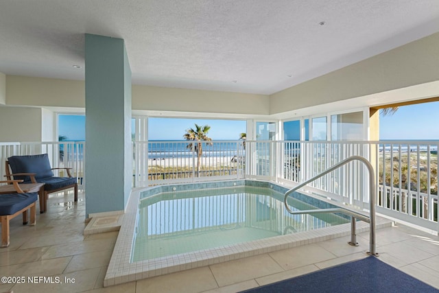 view of swimming pool with a jacuzzi and a water view