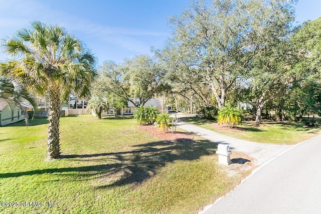 view of property's community with a yard