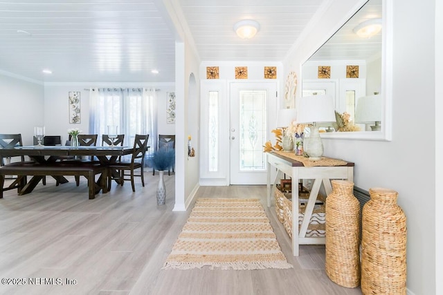 entrance foyer featuring light hardwood / wood-style flooring and ornamental molding