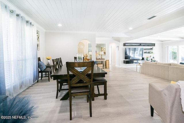 dining room featuring light hardwood / wood-style flooring, wood ceiling, and ornamental molding