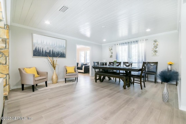 dining room with light hardwood / wood-style flooring, crown molding, and wood ceiling