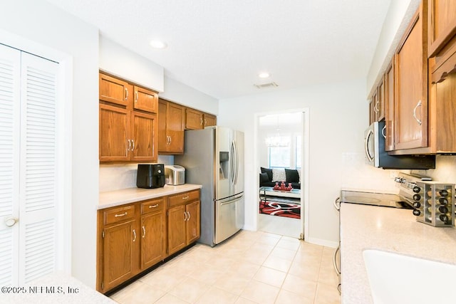 kitchen featuring light tile patterned flooring, stainless steel fridge with ice dispenser, and sink