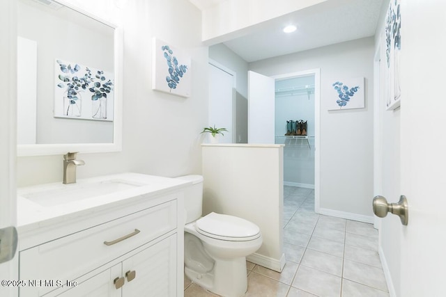 bathroom featuring tile patterned flooring, vanity, and toilet