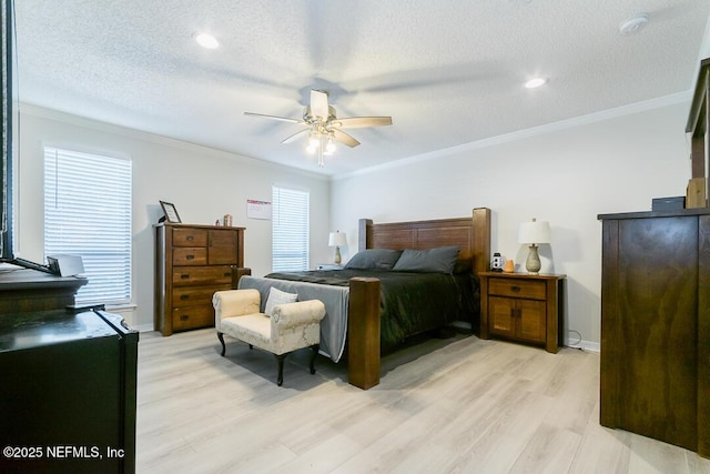 bedroom with a textured ceiling, light wood-type flooring, ceiling fan, and crown molding