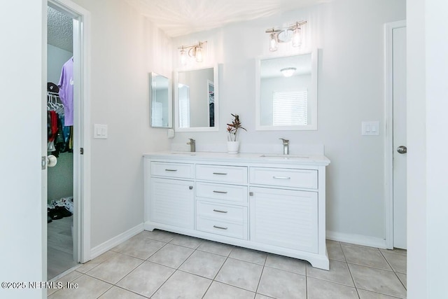 bathroom featuring vanity, a textured ceiling, and tile patterned floors