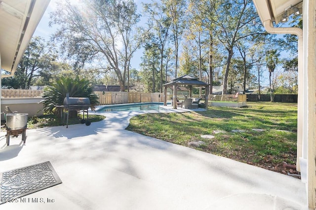 view of pool with a gazebo, a grill, a yard, and a patio