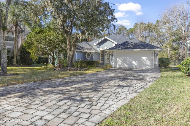 view of front of property featuring a front lawn and a garage