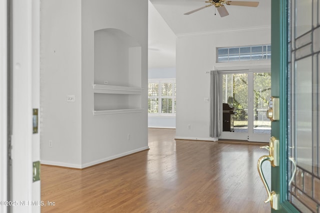 foyer with ceiling fan, crown molding, and hardwood / wood-style flooring