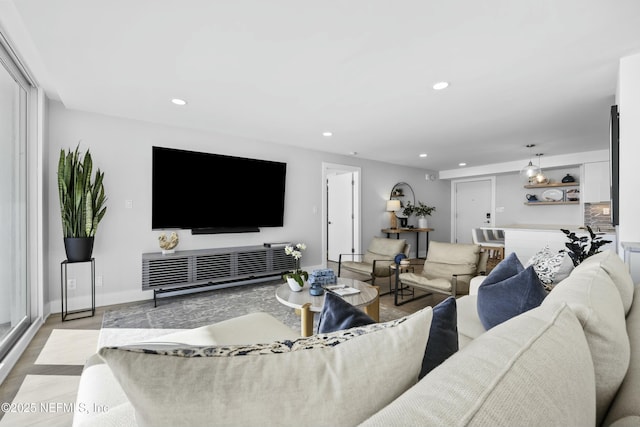 living room with light hardwood / wood-style floors and a chandelier