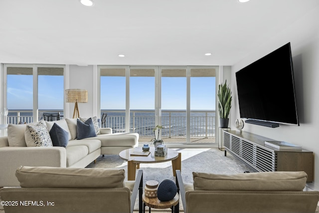 living room featuring a wealth of natural light and a wall of windows