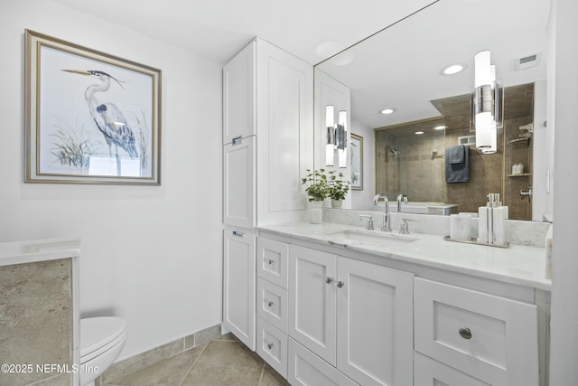 bathroom with tiled shower, tile patterned flooring, vanity, and toilet