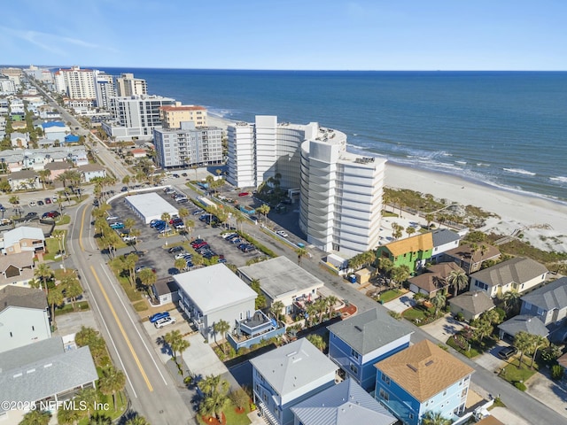 birds eye view of property with a view of the beach and a water view