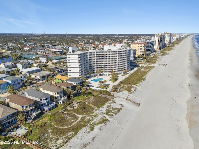 drone / aerial view with a water view and a view of the beach