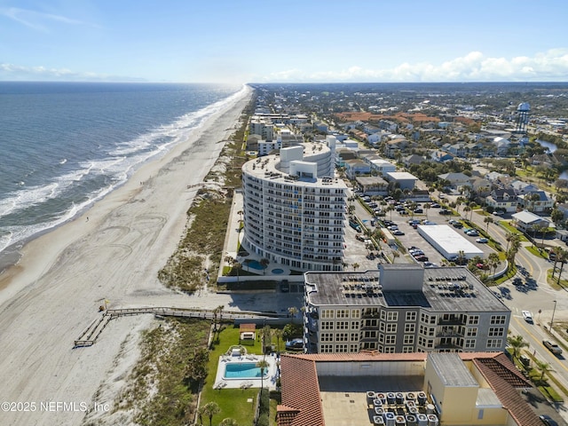 drone / aerial view with a water view and a view of the beach