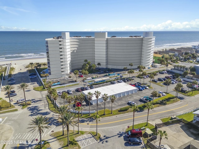 drone / aerial view featuring a beach view and a water view