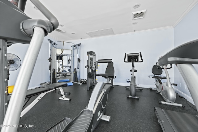 workout area featuring crown molding