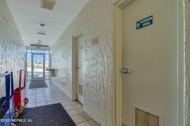 corridor featuring light tile patterned floors