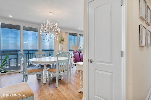 dining room featuring an inviting chandelier and light wood-type flooring