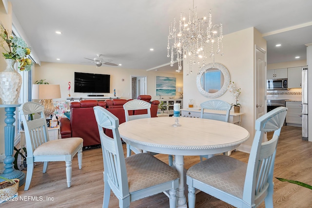 dining area featuring ceiling fan and light wood-type flooring