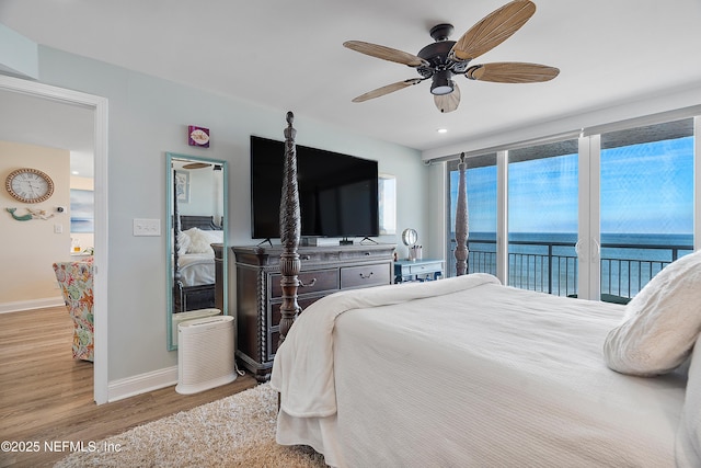 bedroom featuring hardwood / wood-style flooring, access to outside, and ceiling fan