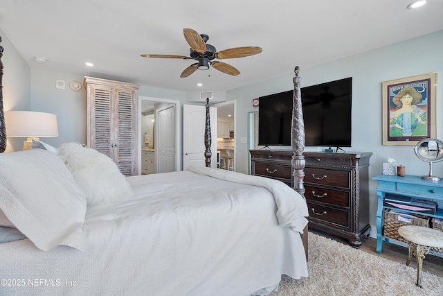 bedroom with ceiling fan, ensuite bathroom, and light wood-type flooring