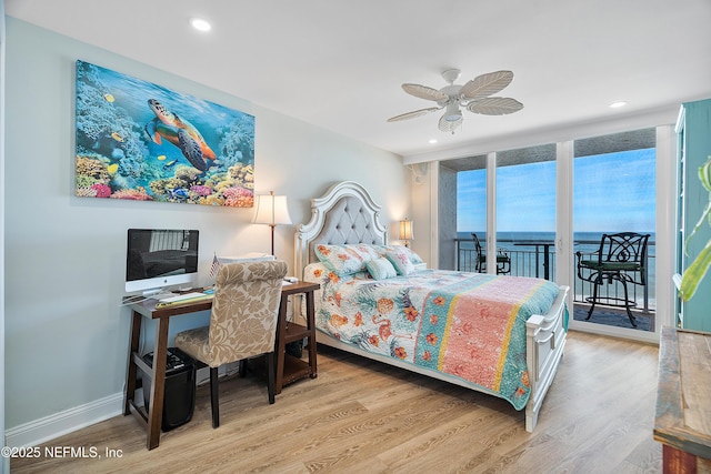 bedroom featuring light hardwood / wood-style flooring, floor to ceiling windows, ceiling fan, and access to outside