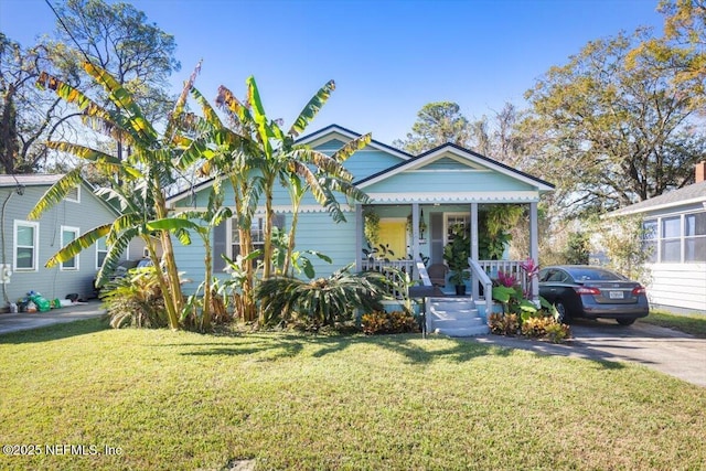 bungalow-style house with covered porch and a front lawn