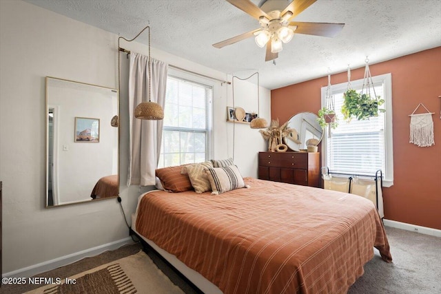 bedroom with carpet, ceiling fan, and a textured ceiling