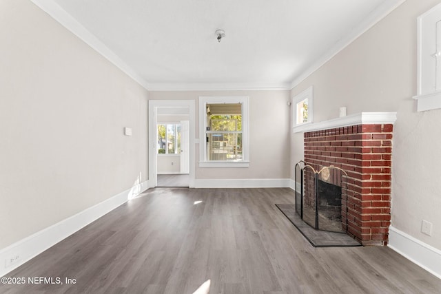 unfurnished living room with a fireplace, hardwood / wood-style floors, and ornamental molding