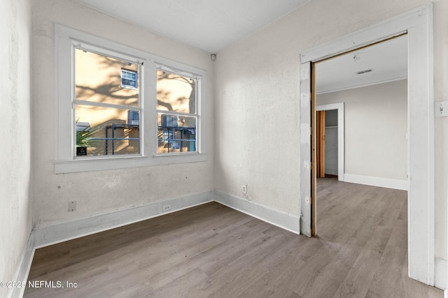 unfurnished room with wood-type flooring