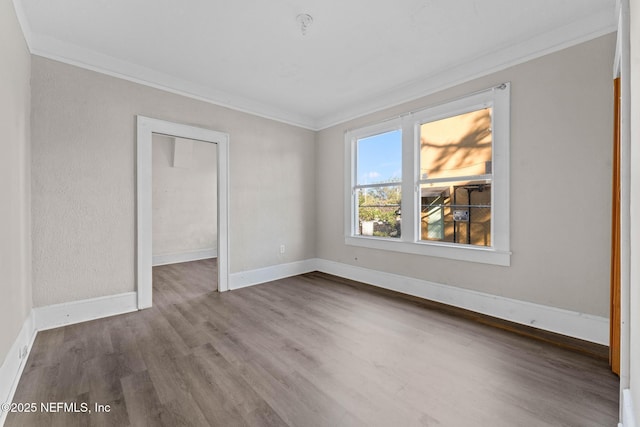 unfurnished room featuring crown molding and hardwood / wood-style flooring