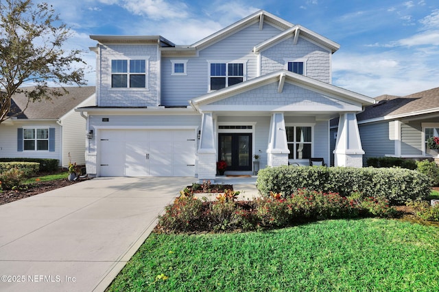 craftsman inspired home with a porch, a garage, and french doors