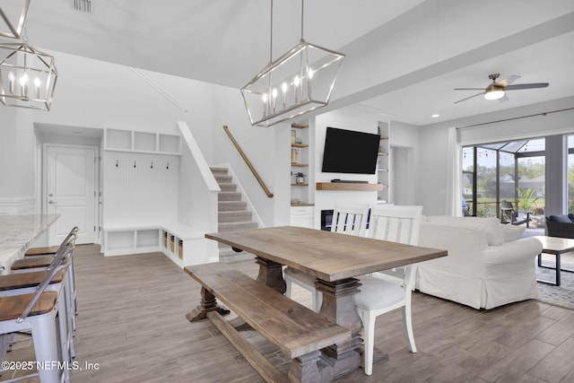 dining area featuring wood-type flooring and ceiling fan