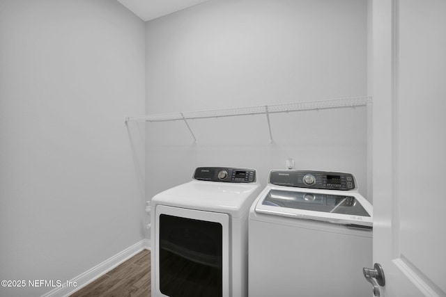 laundry room featuring washer and clothes dryer and dark hardwood / wood-style flooring