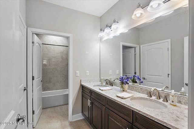 bathroom featuring vanity and tiled shower / bath combo