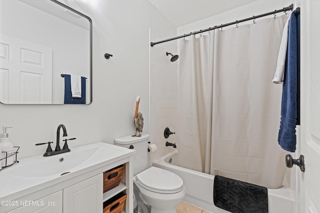 full bathroom featuring shower / tub combo with curtain, vanity, a textured ceiling, and toilet