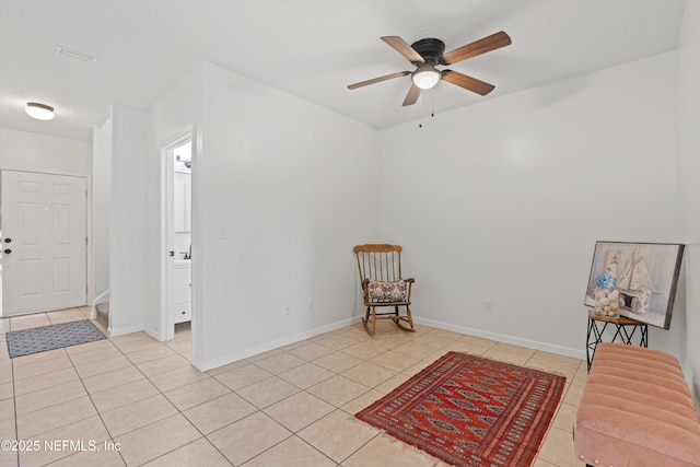 sitting room featuring light tile patterned floors and ceiling fan