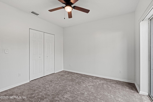 unfurnished bedroom featuring carpet, a closet, and ceiling fan