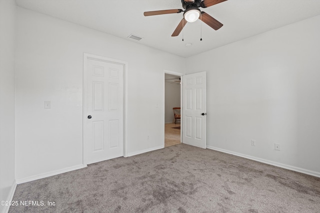 unfurnished bedroom featuring light colored carpet and ceiling fan