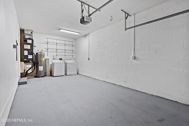 garage with washing machine and clothes dryer, heating unit, a garage door opener, and water heater