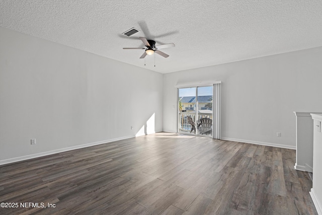 spare room with ceiling fan, a textured ceiling, and dark wood-type flooring