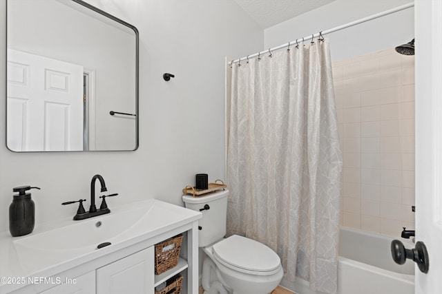 full bathroom featuring vanity, toilet, shower / bath combo with shower curtain, and a textured ceiling