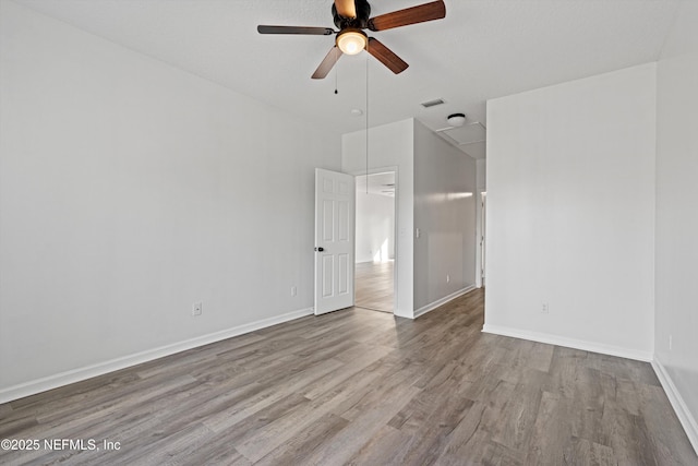 empty room featuring light wood-type flooring and ceiling fan