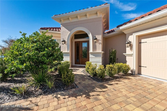 view of exterior entry featuring a garage